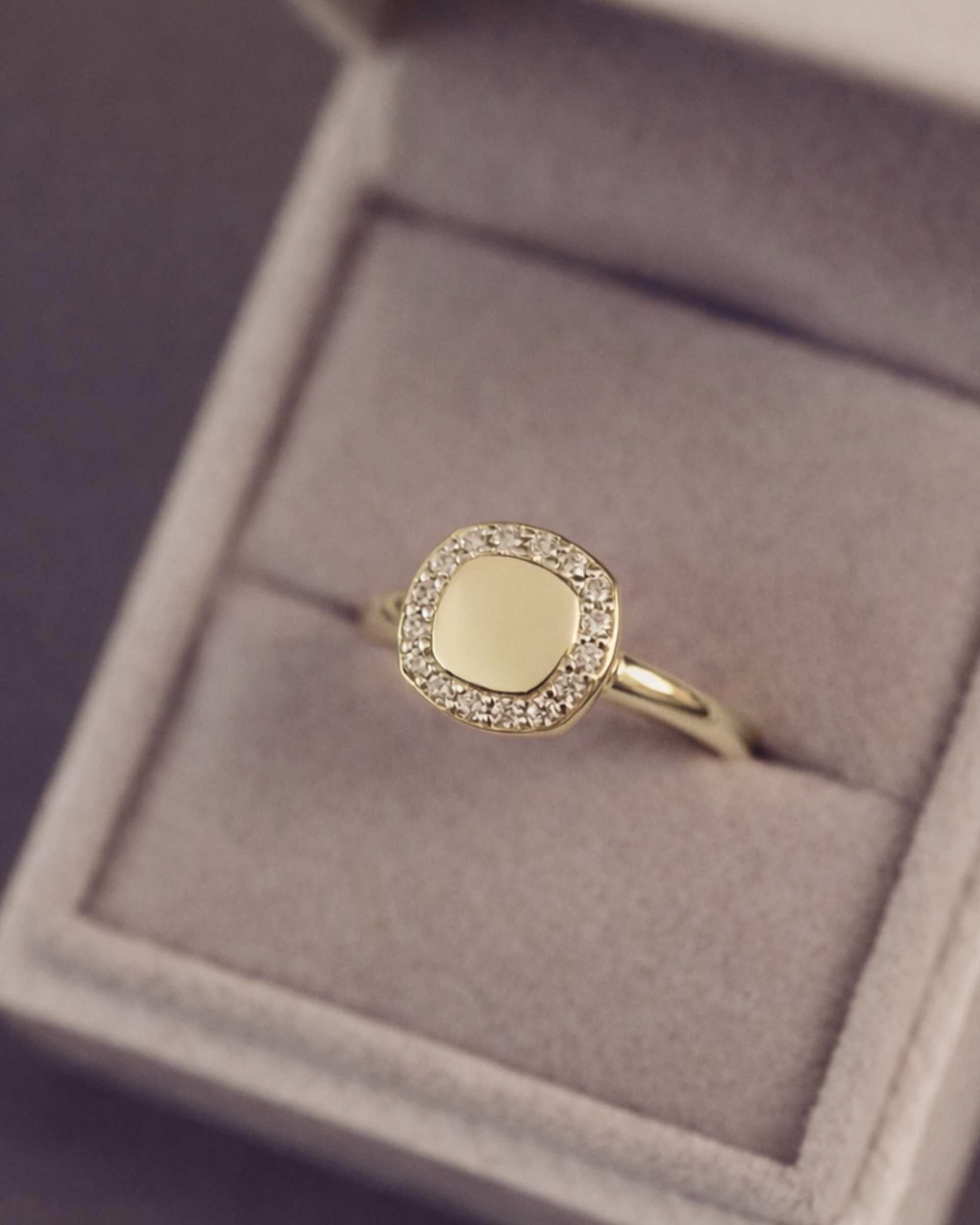 Gold ring with gemstone accents in a jewellery box