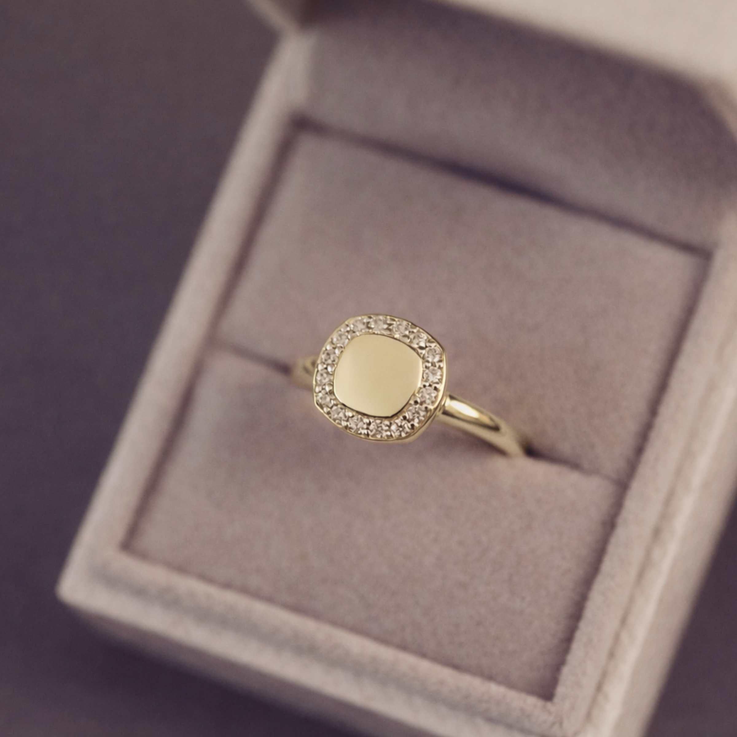 Gold ring with gemstone accents in a jewellery box