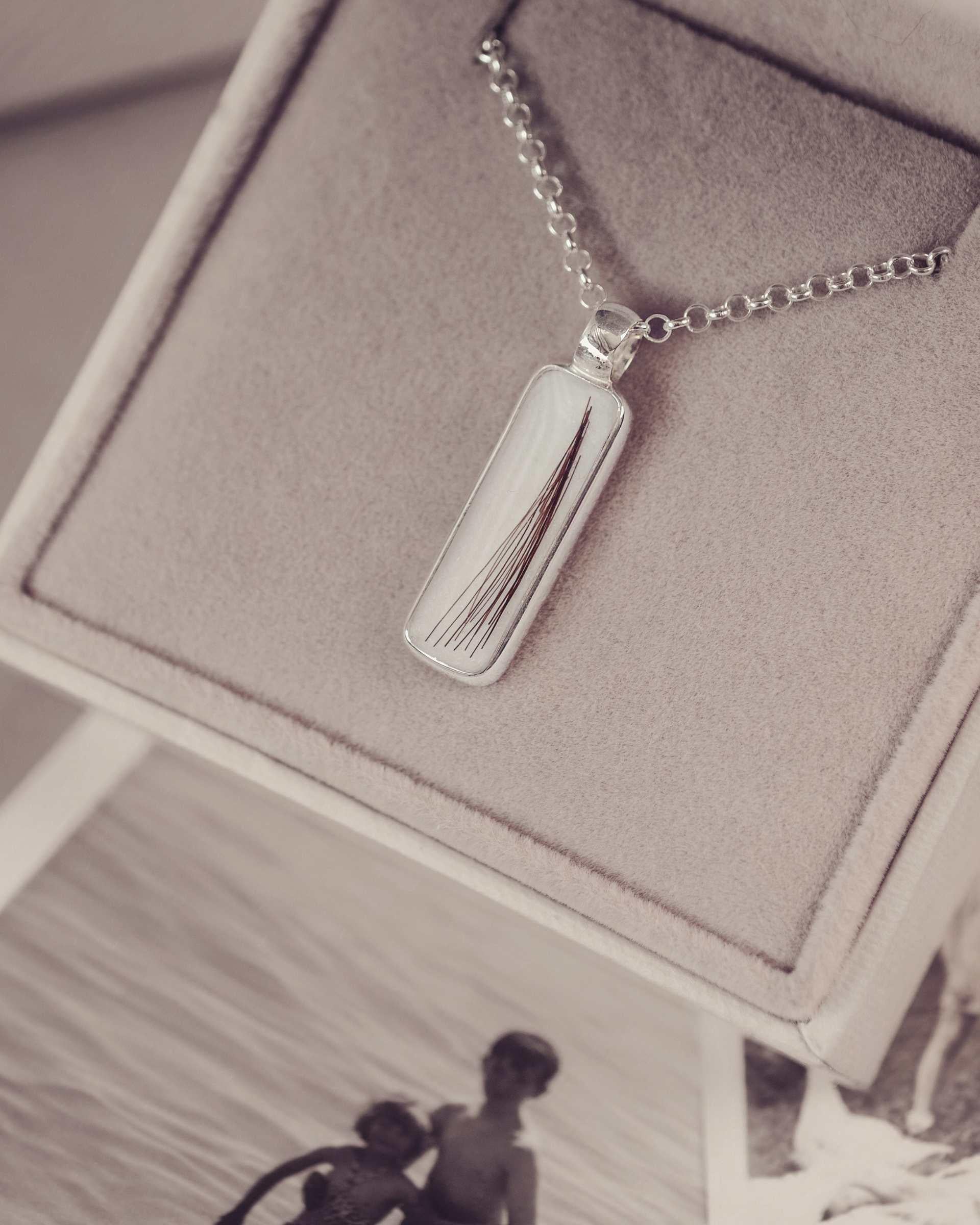 Silver necklace with a rectangular pendant in a jewellery box