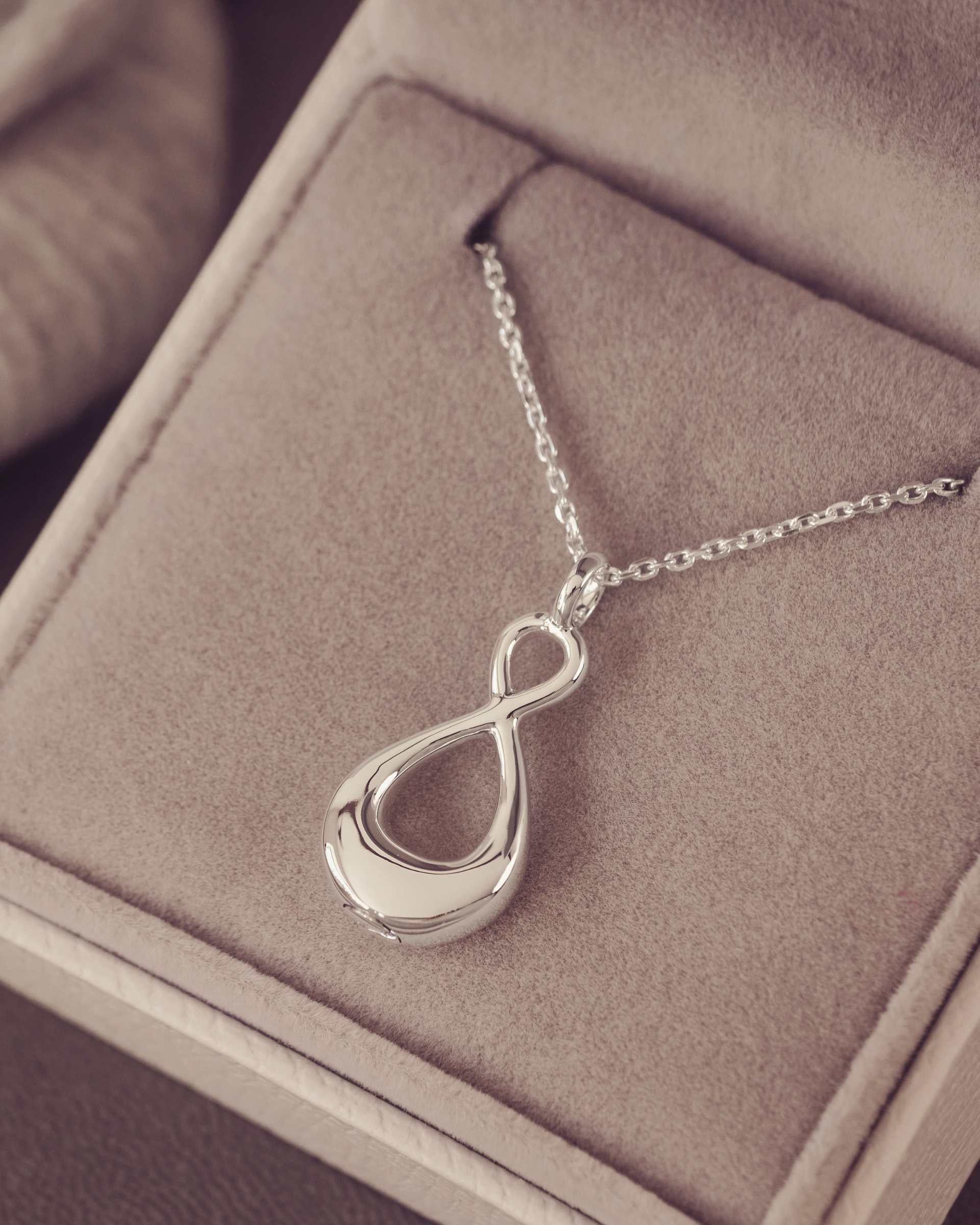 Silver necklace with an infinity pendant in a jewellery box