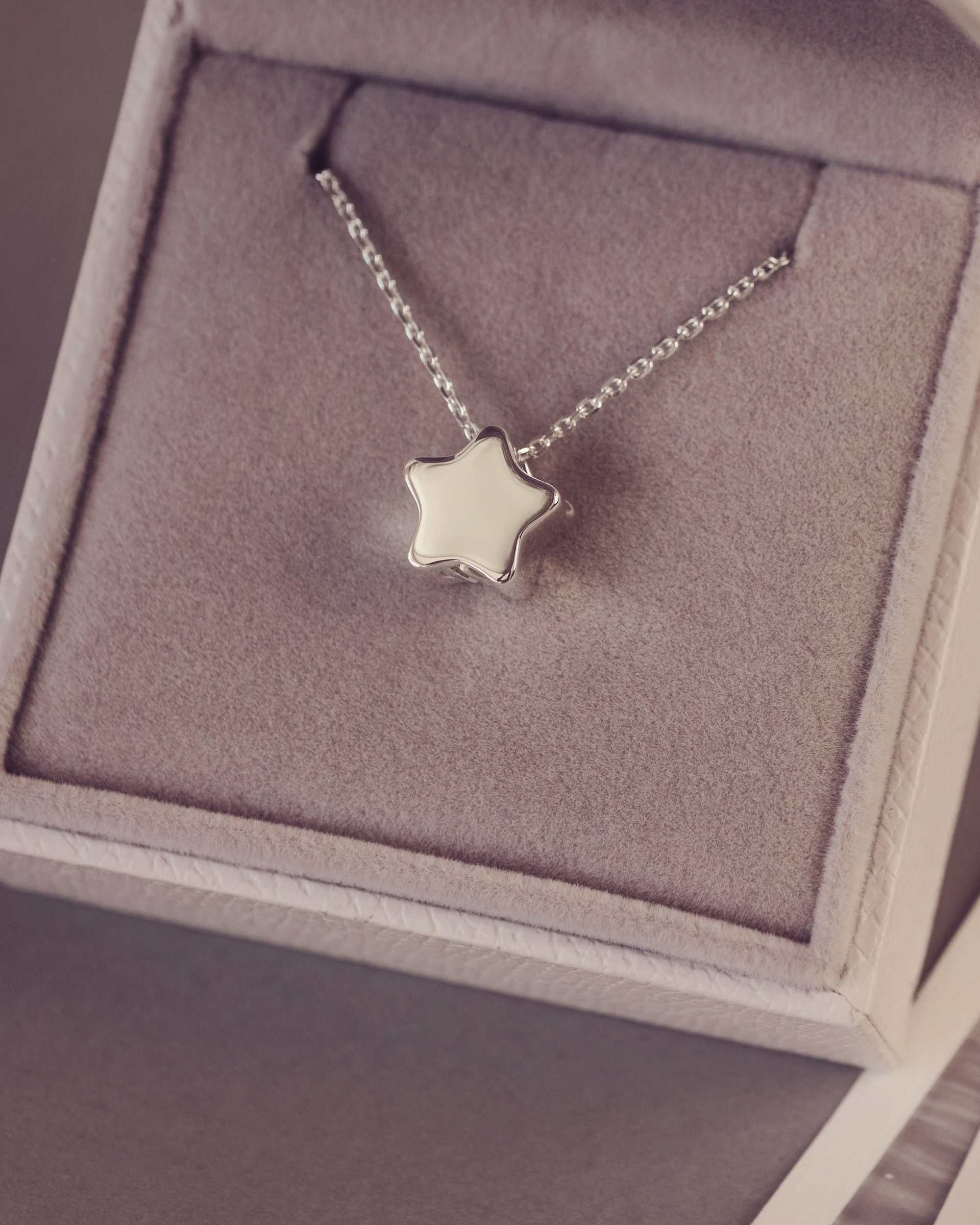 Silver star necklace in a jewellery box