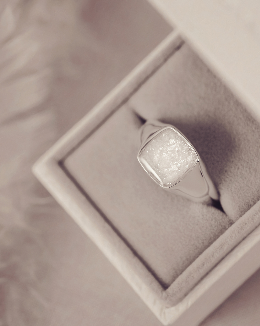 Silver ring with a textured surface in a jewelry box