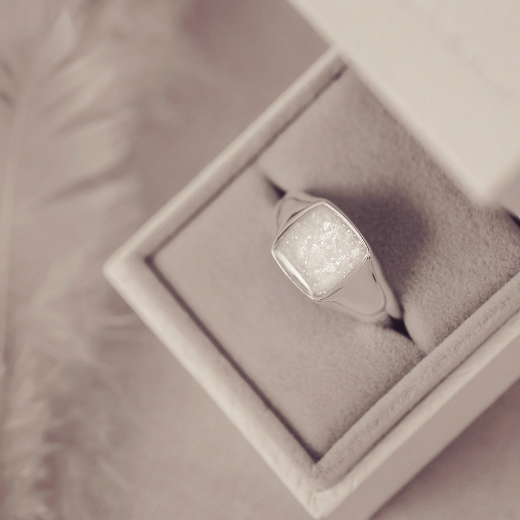 Silver ring with a textured surface in a jewelry box