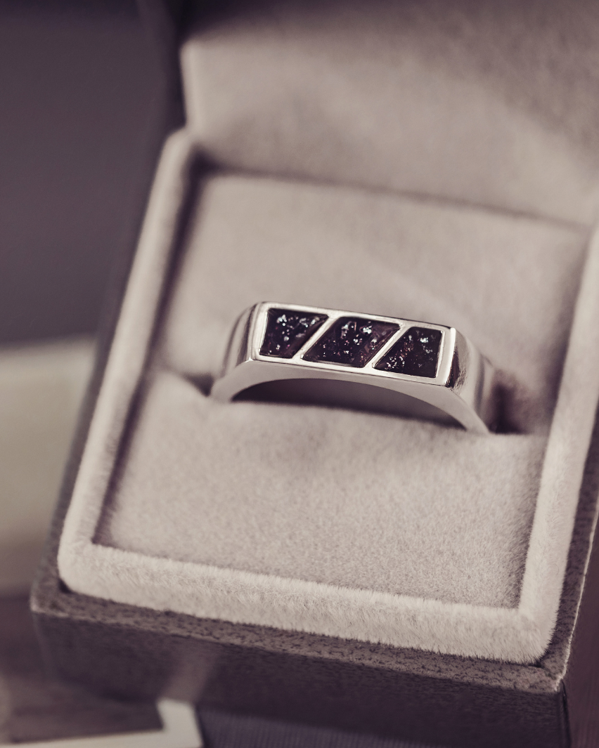 Silver ring with embedded stones in a jewelry box