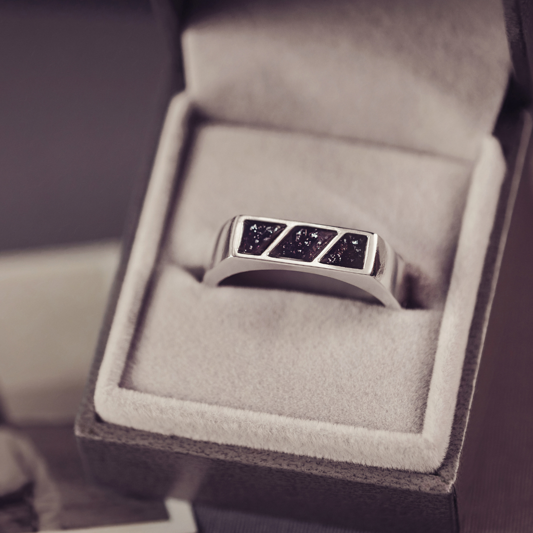 Silver ring with embedded stones in a jewelry box