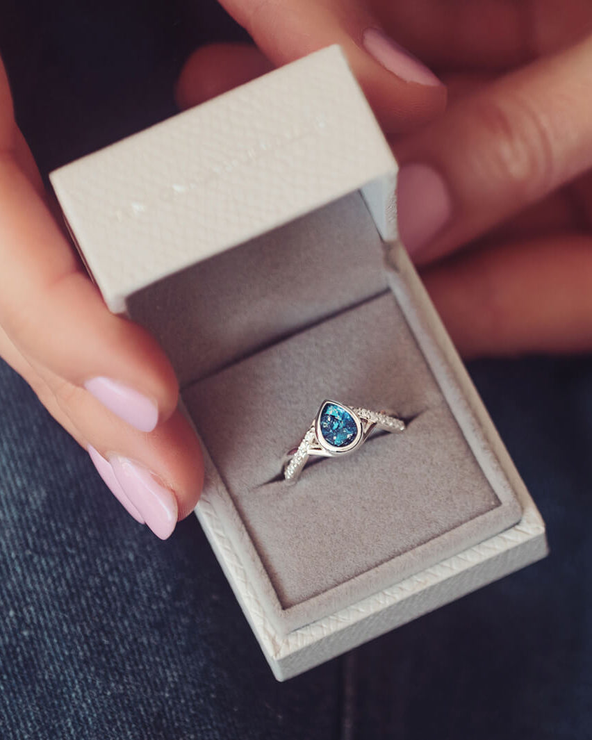 Sterling Silver Peardrop Ring with Crystals on the Band, holding cremation ashes and blue crystal