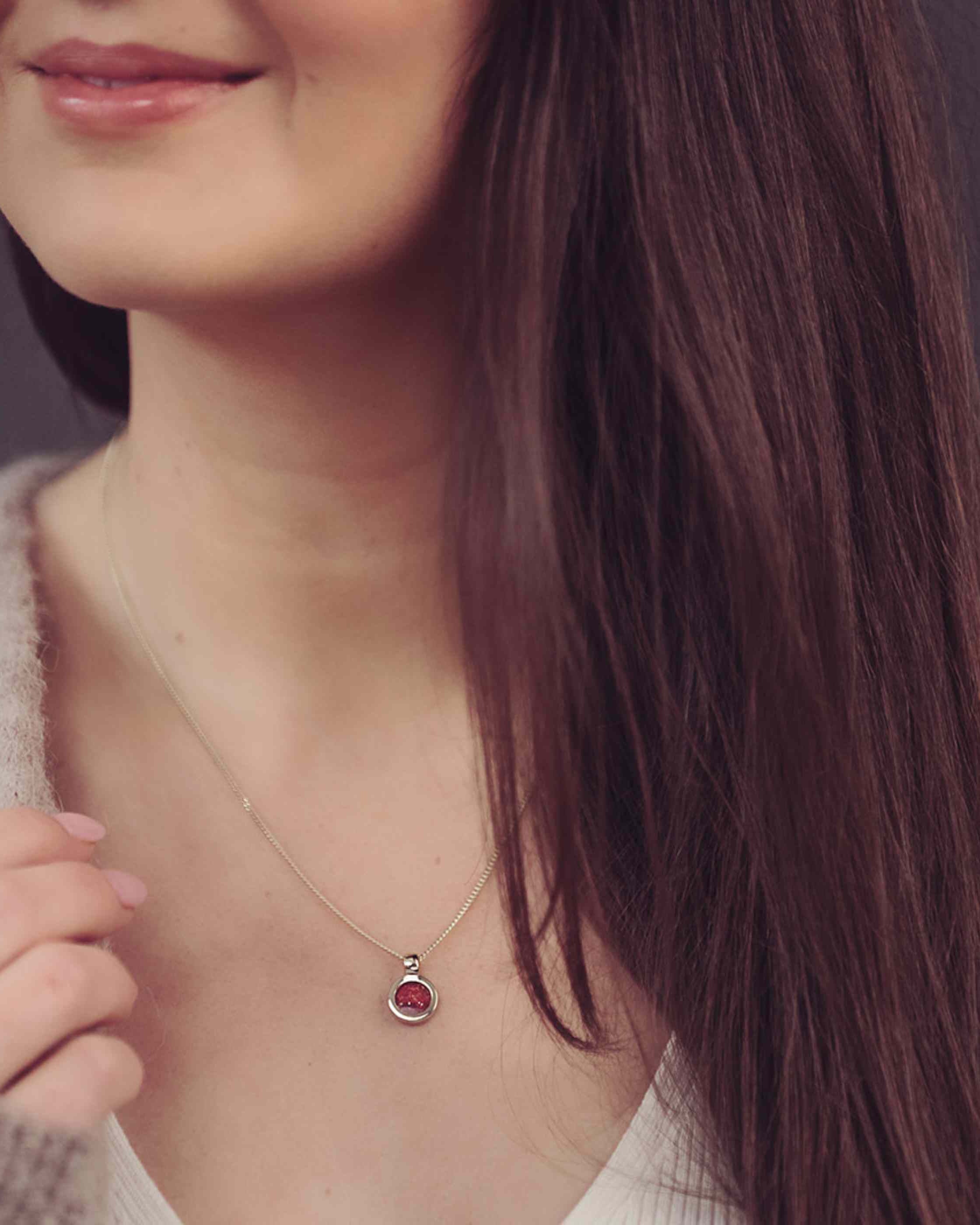Red Gold Ashes Necklace being worn on woman