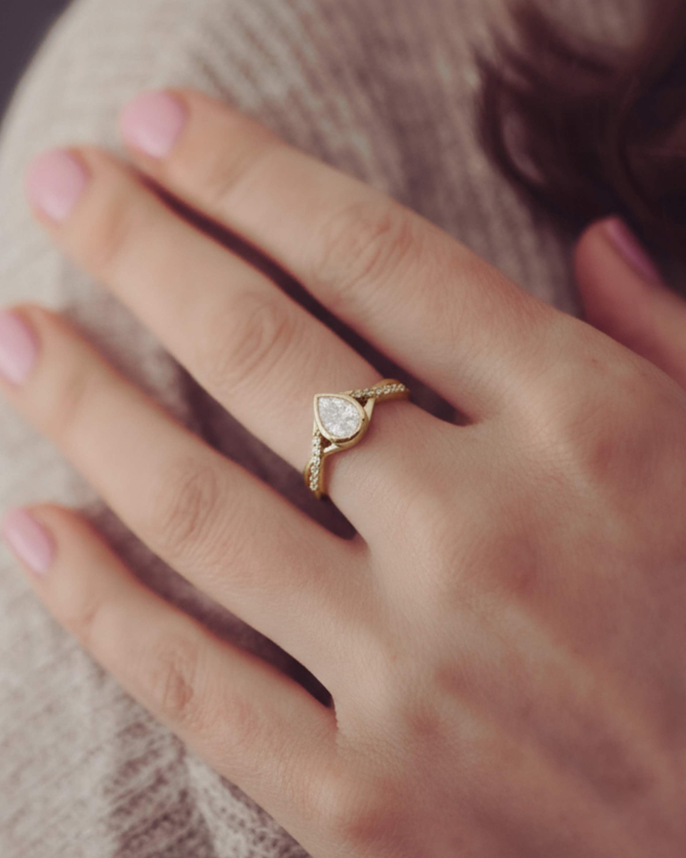 Gold ring with a diamond on a person's finger