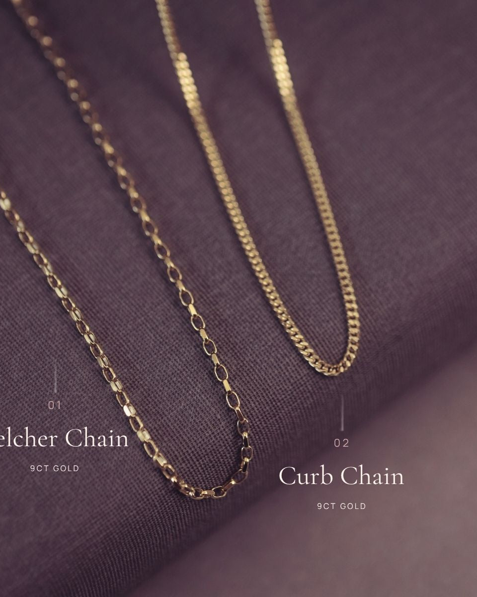 Gold chain necklace on a purple fabric background with 'Curb' and 'Belcher' labels.