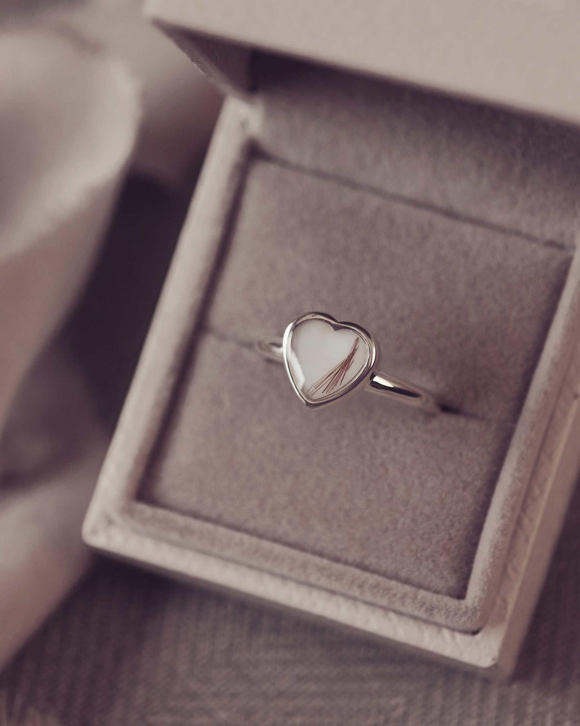 Heart-shaped ring in a jewellery box with a blurred background