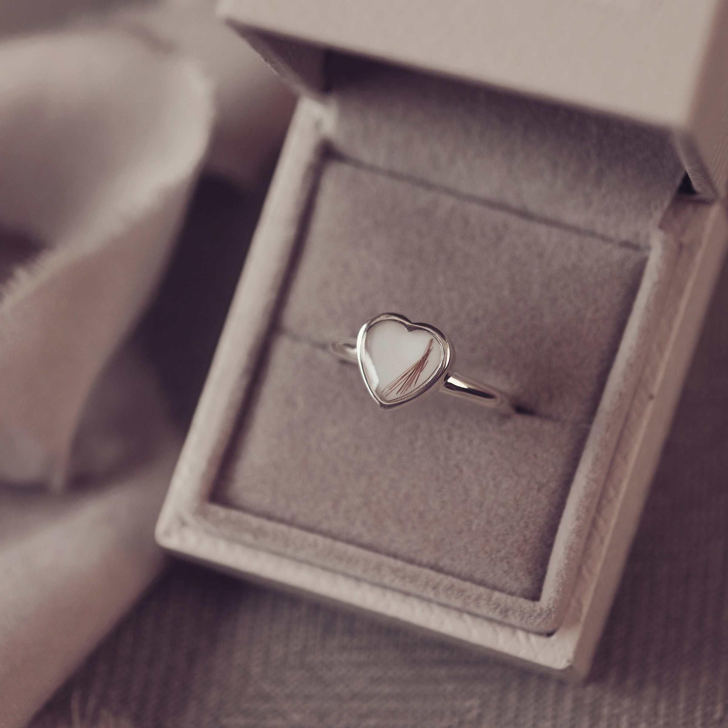 Heart-shaped ring in a jewellery box with a blurred background