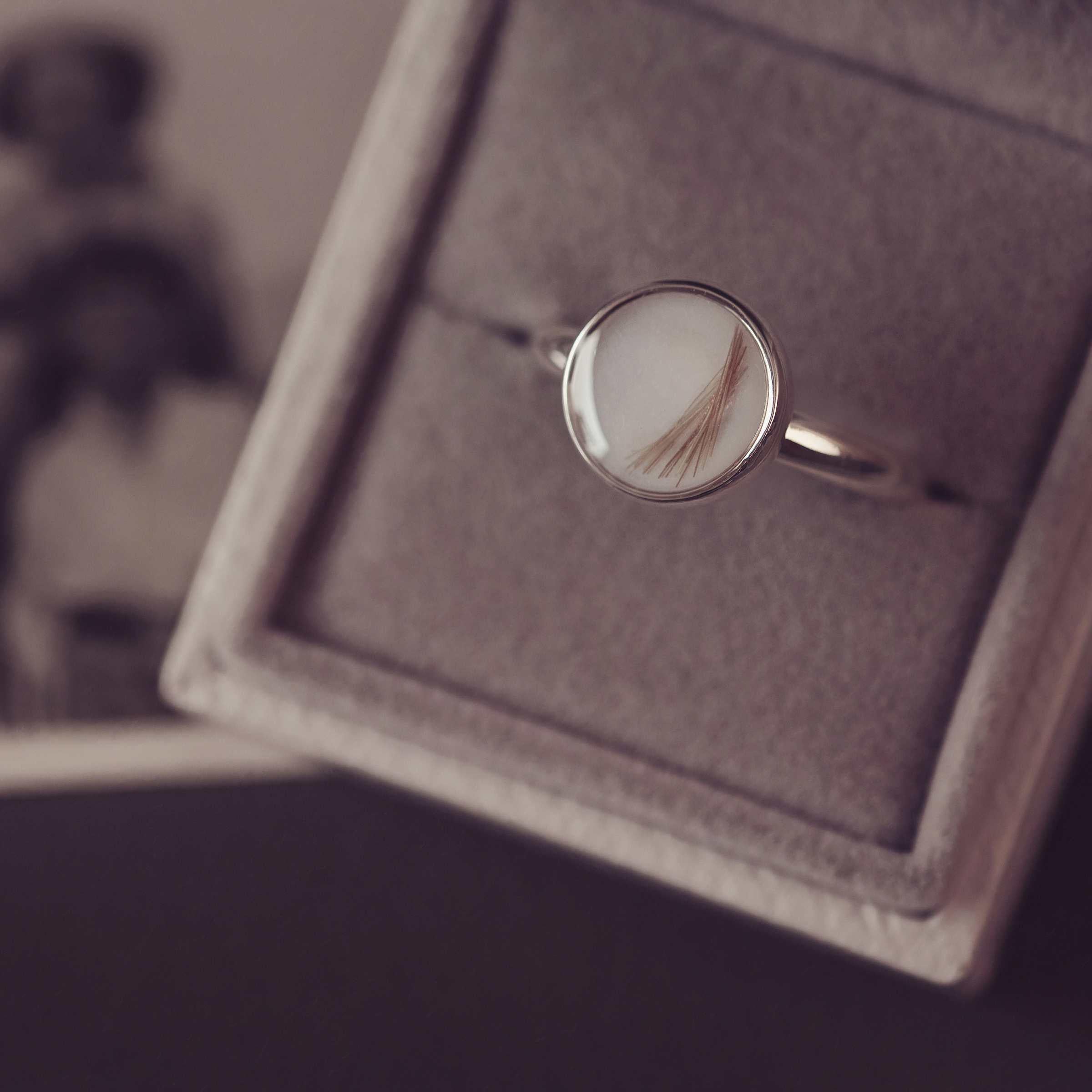 Silver ring with a circular design in a jewellery box