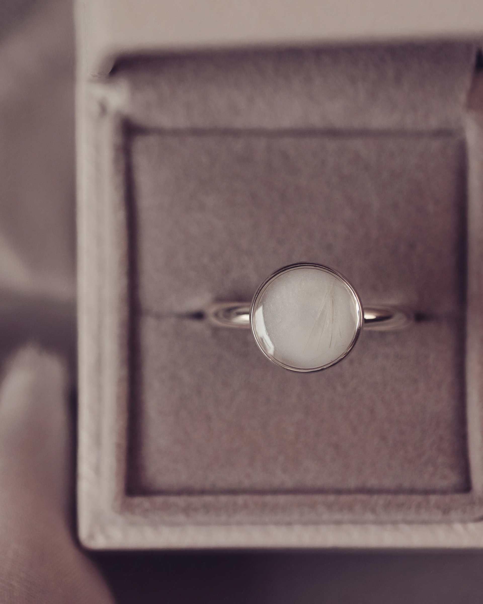 Silver ring with a round shape in a jewellery box