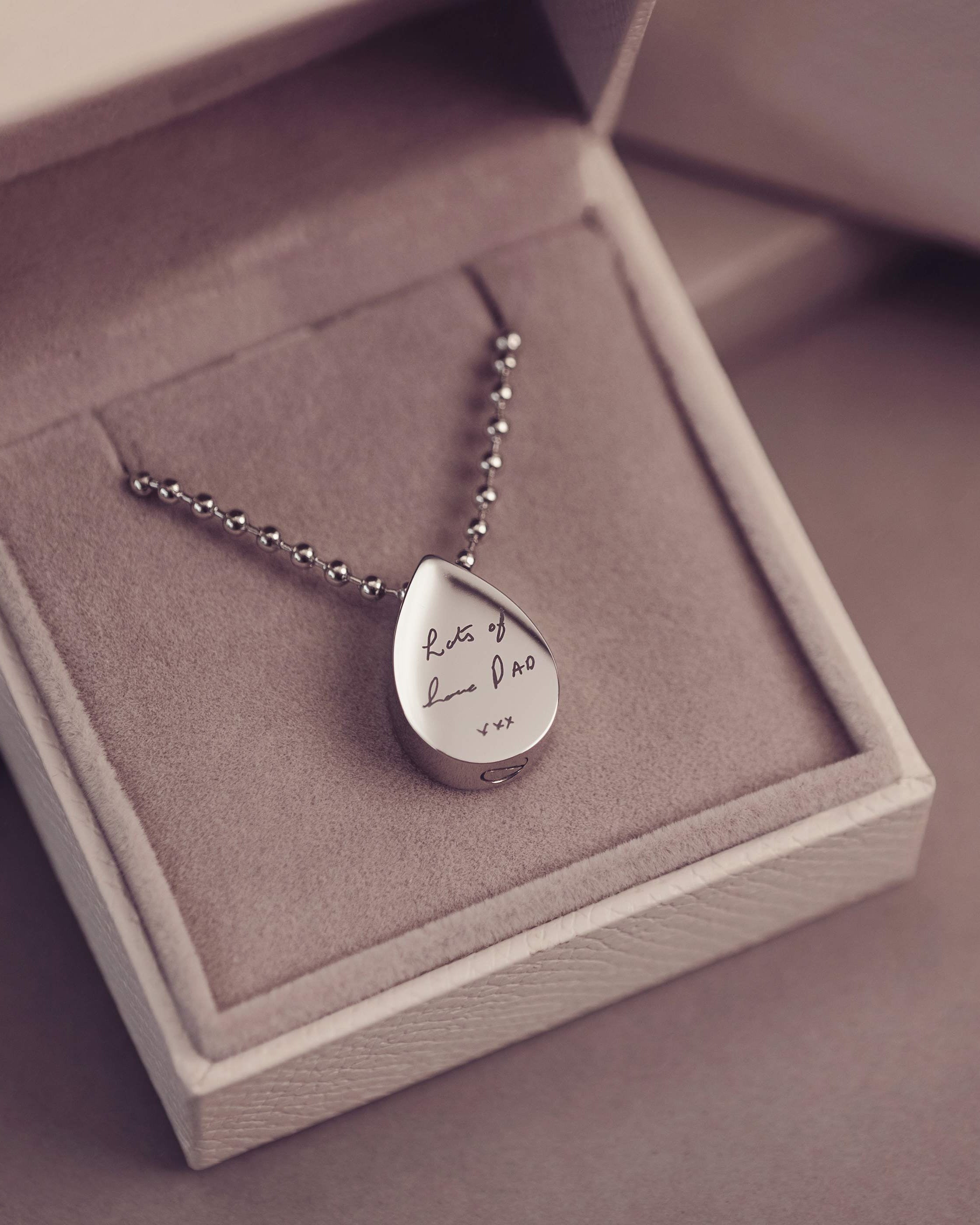 Silver teardrop pendant necklace in a jewelry box