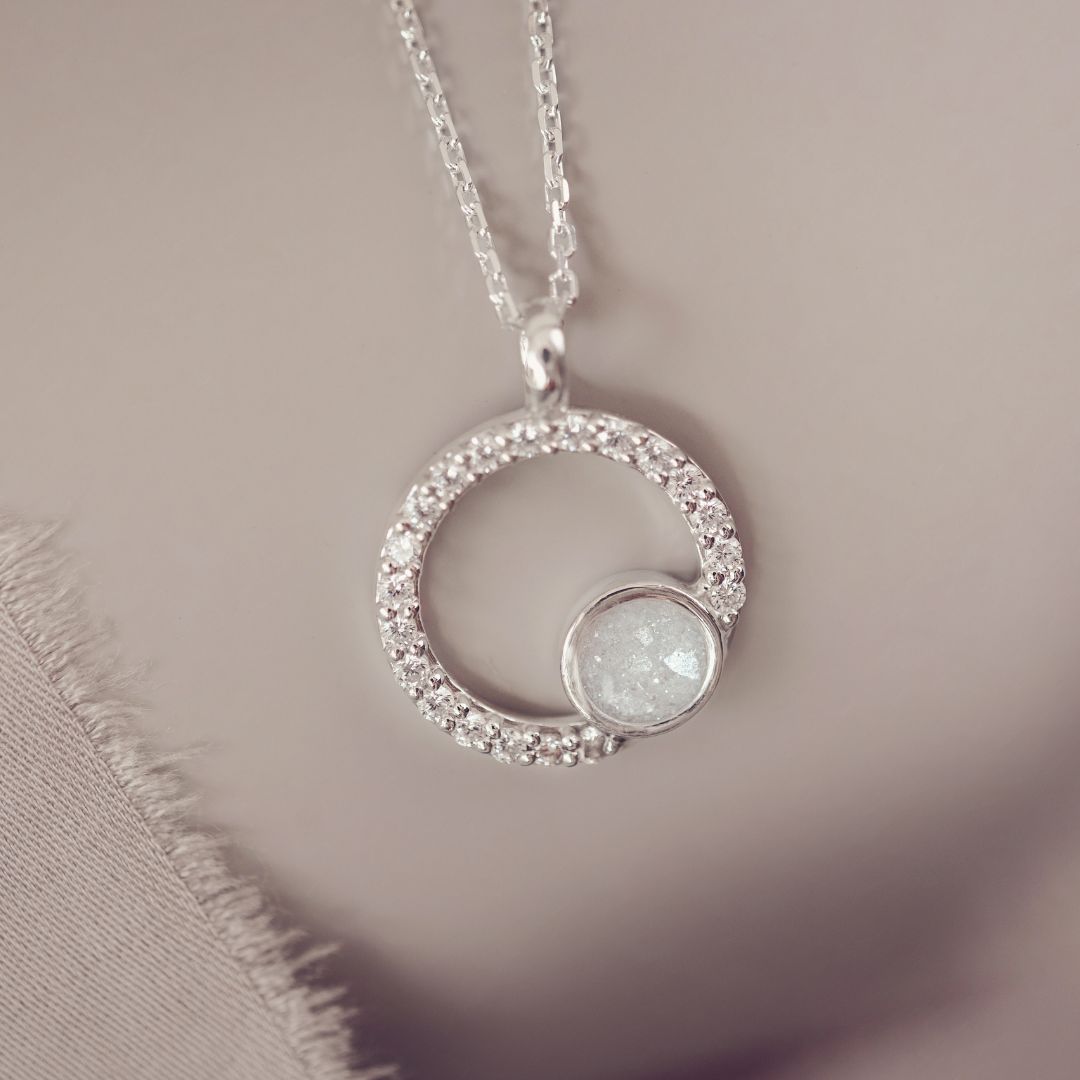 Silver necklace with a circular pendant on a soft background