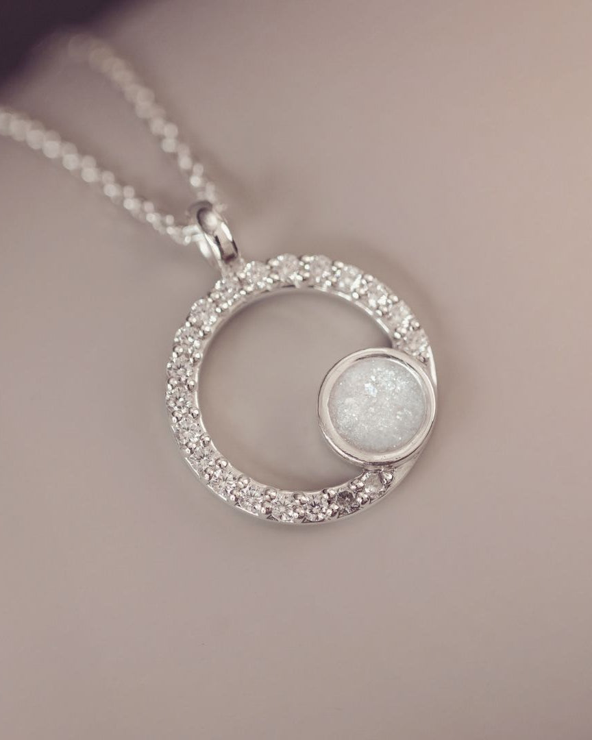 Silver necklace with a circular pendant on a soft background