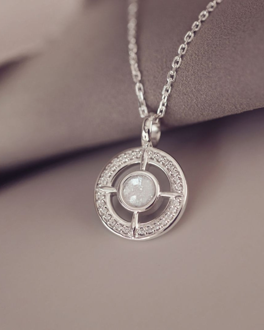 Silver necklace with a circular pendant on a soft background