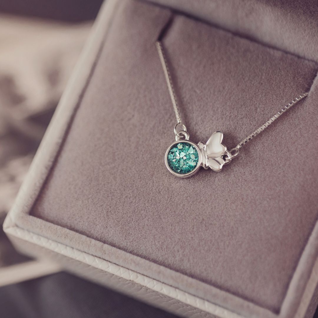 Necklace with a green gemstone pendant on a soft surface