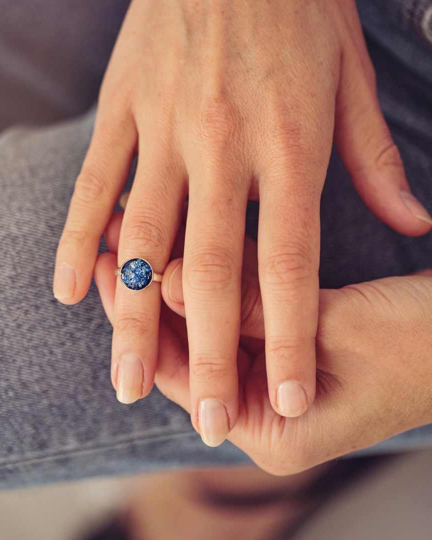 blue round silver ring filled with cremation ashes