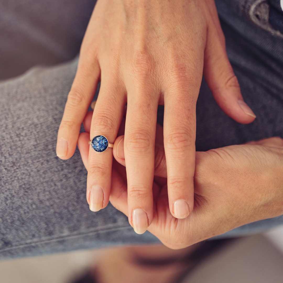 blue round silver ring filled with cremation ashes