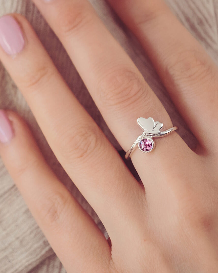 Sterling Silver Butterfly Ring, holding cremation ashes and pink crystal, on a ladies hand