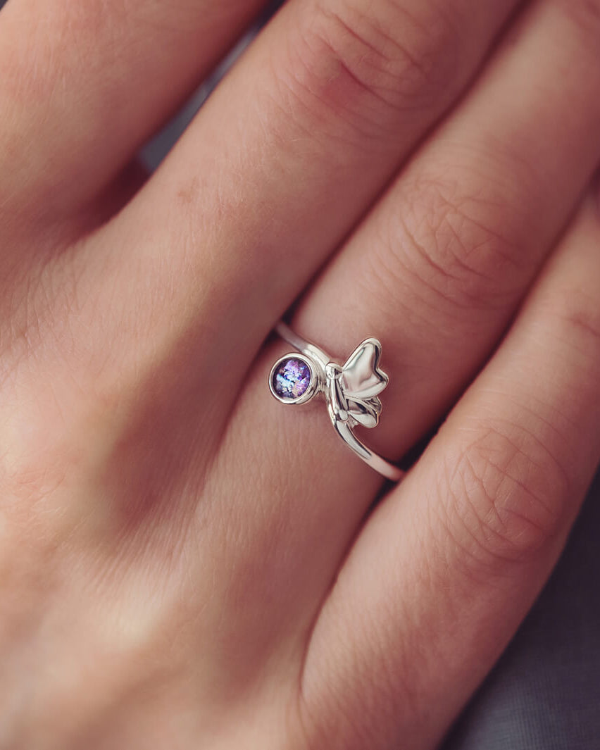 Sterling Silver Butterfly Ring, holding cremation ashes and purple crystal, on a ladies hand