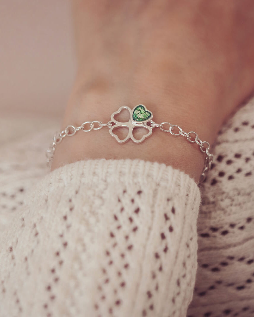 sterling silver chain bracelet with clover shaped charm holding green crystal and cremation ashes