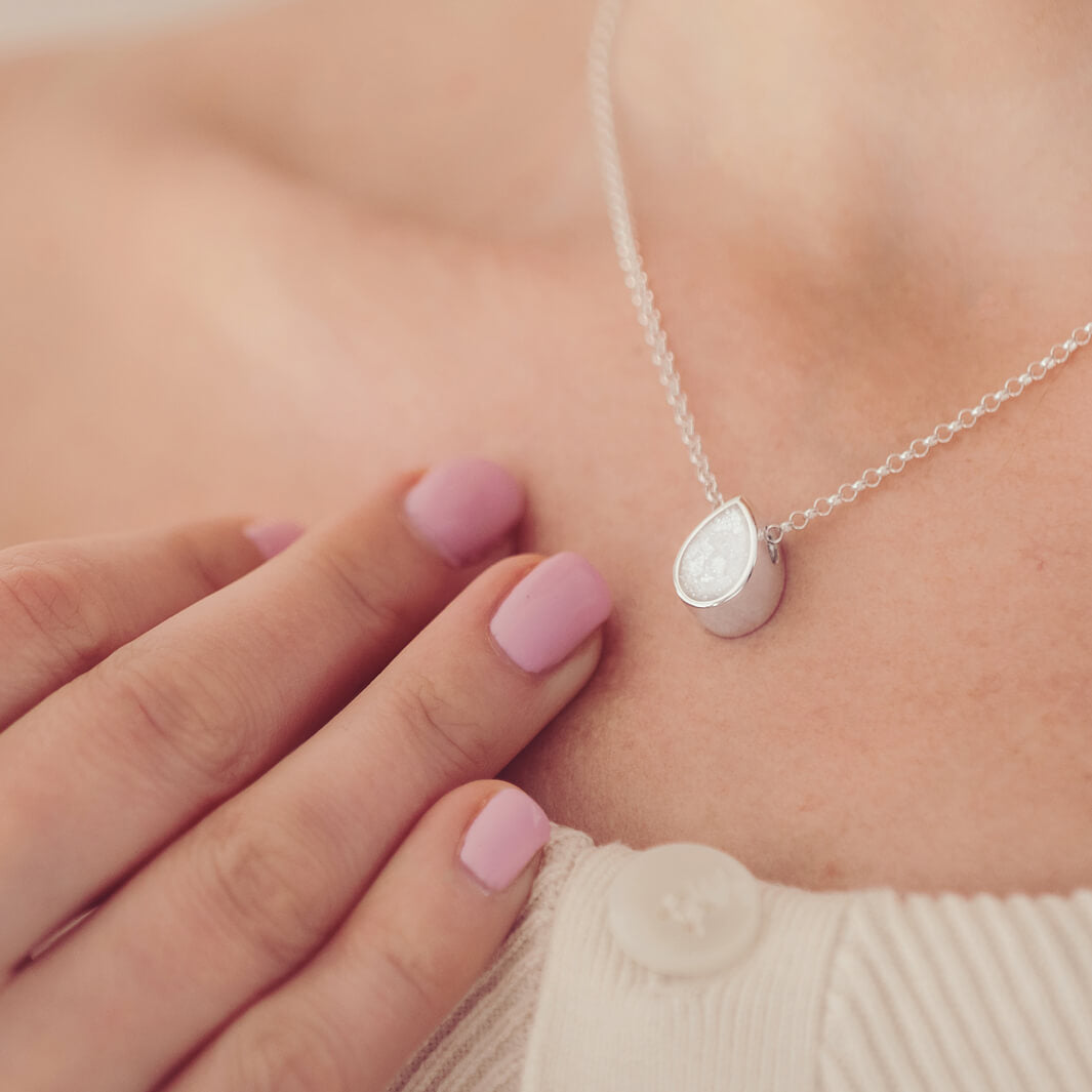 Cremation Ashes Floating Peardrop Necklace, in clear, on a sterling silver chain on a ladies neck