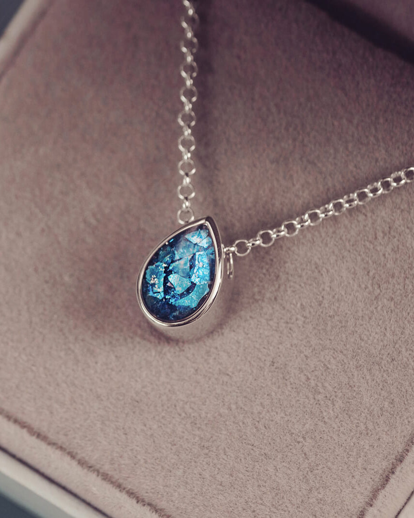 Peardrop shaped silver pendant, filled with blue crystal & cremation ashes, on a silver chain