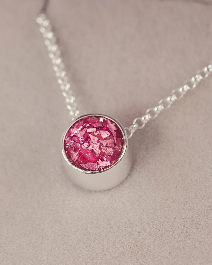 Round silver charm on silver chain, filled with pink crystal, glitter, resin & ashes.