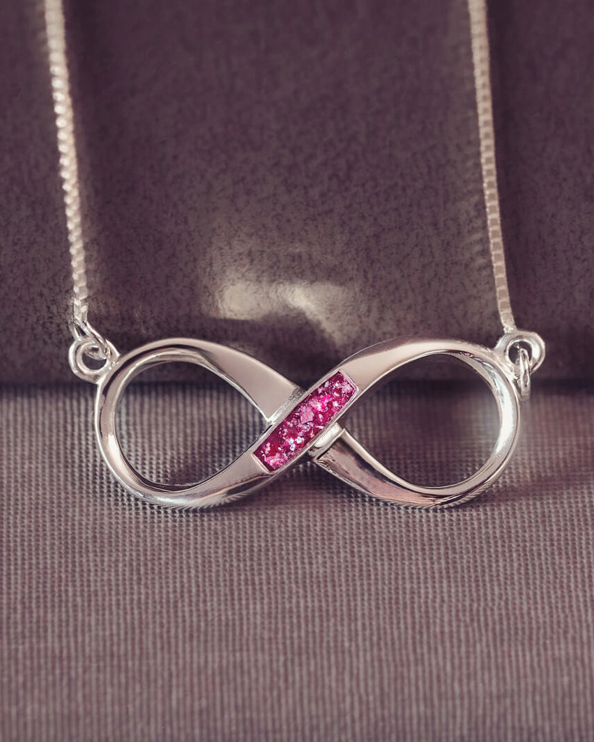 Memorial Ashes Infinity Necklace, in sterling silver, with a section filled with pink crystals and cremation ashes
