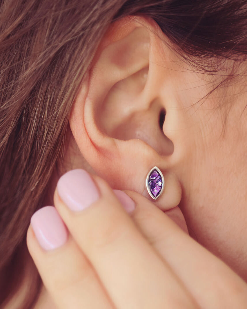 Marquise Style Earrings, worn on a models ear, filled with purple crystal and cremation ashes