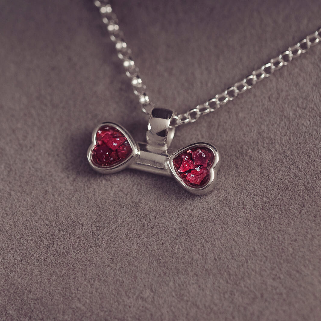 sterling silver bone shaped necklace, filled with cremation ashes, red crystal and resin.