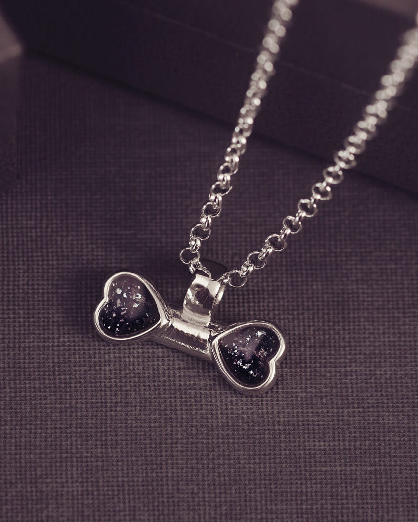 sterling silver bone shaped necklace, filled with cremation ashes, black crystal and resin.