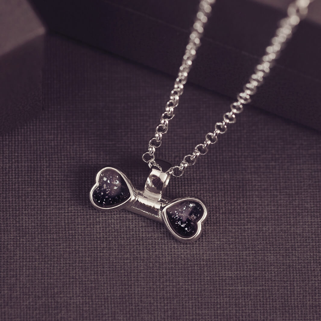 sterling silver bone shaped necklace, filled with cremation ashes, black crystal and resin.
