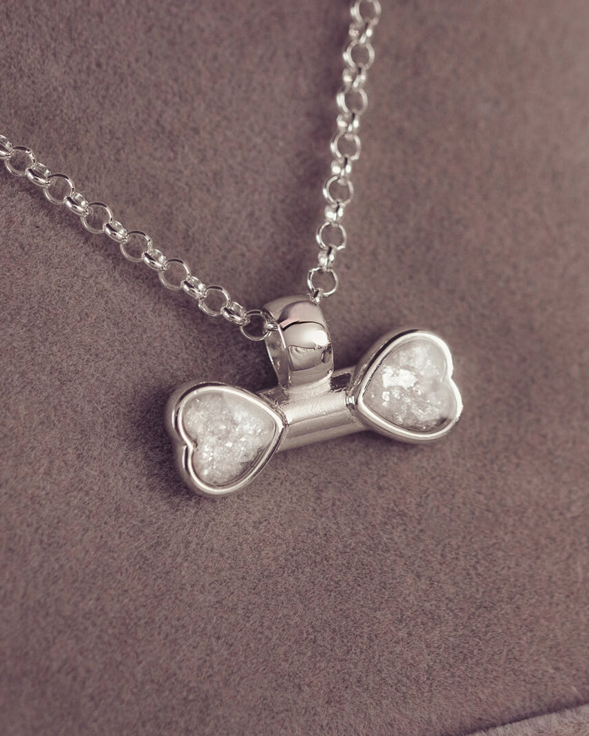 sterling silver bone shaped necklace, filled with cremation ashes, clear crystal and resin.