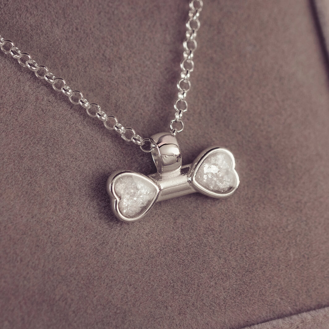 sterling silver bone shaped necklace, filled with cremation ashes, clear crystal and resin.