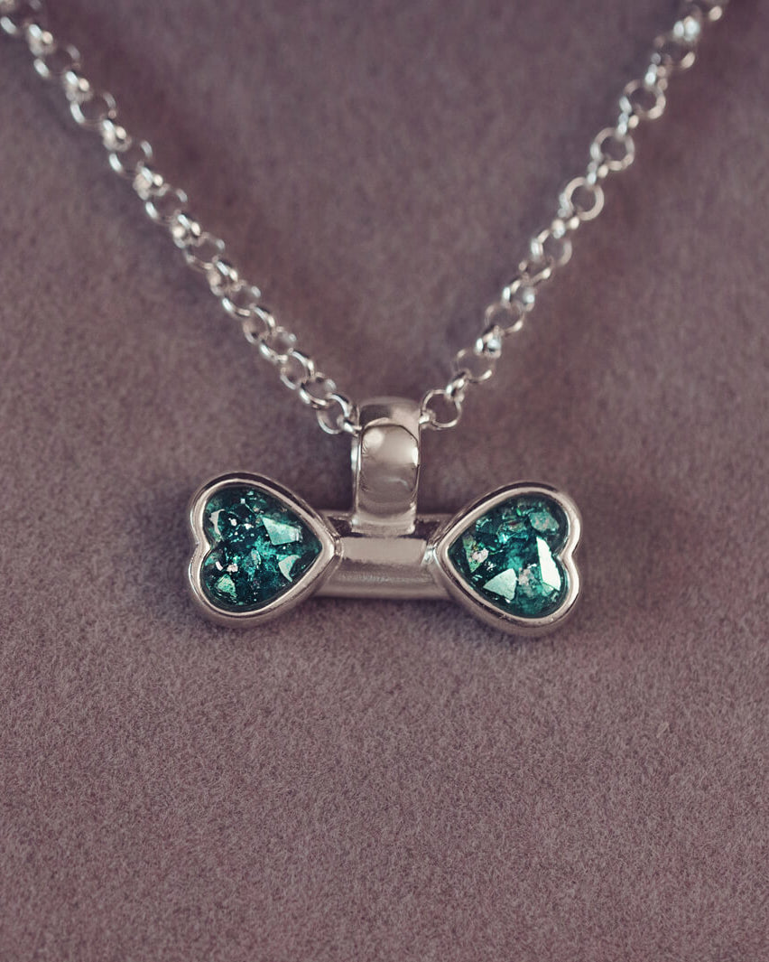 sterling silver bone shaped necklace, filled with cremation ashes, green crystal and resin.