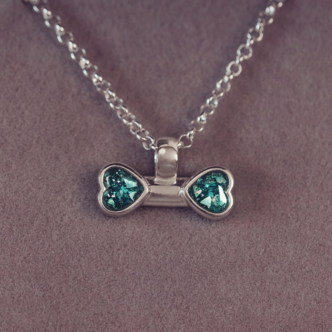 sterling silver bone shaped necklace, filled with cremation ashes, green crystal and resin.