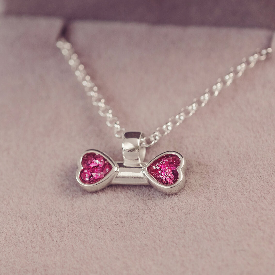 sterling silver bone shaped necklace, filled with cremation ashes, pink crystal and resin.