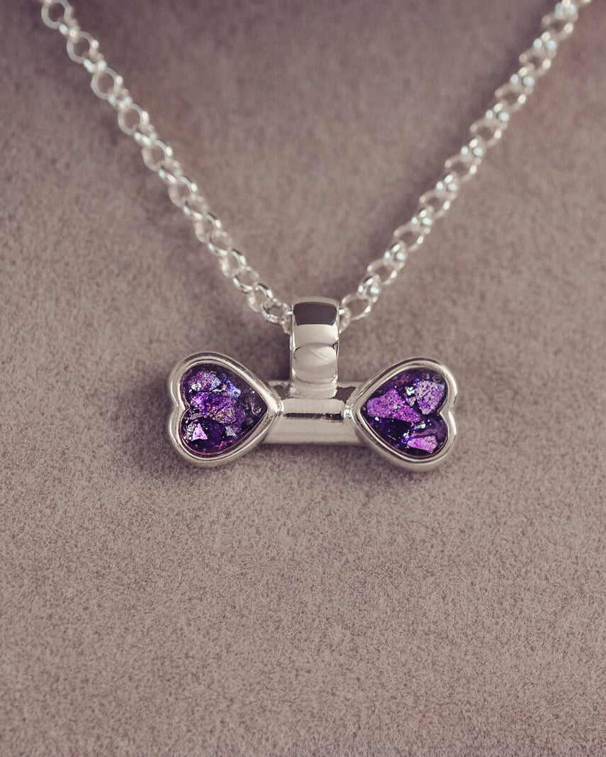 sterling silver bone shaped necklace, filled with cremation ashes, purple crystal and resin.
