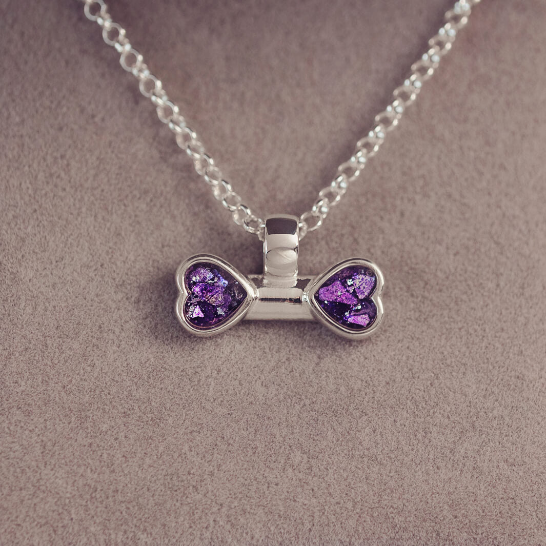 sterling silver bone shaped necklace, filled with cremation ashes, purple crystal and resin.