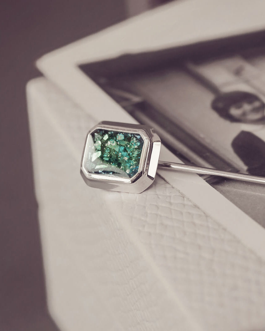 silver tie pin, created with green crystals, resin and cremation ashes.