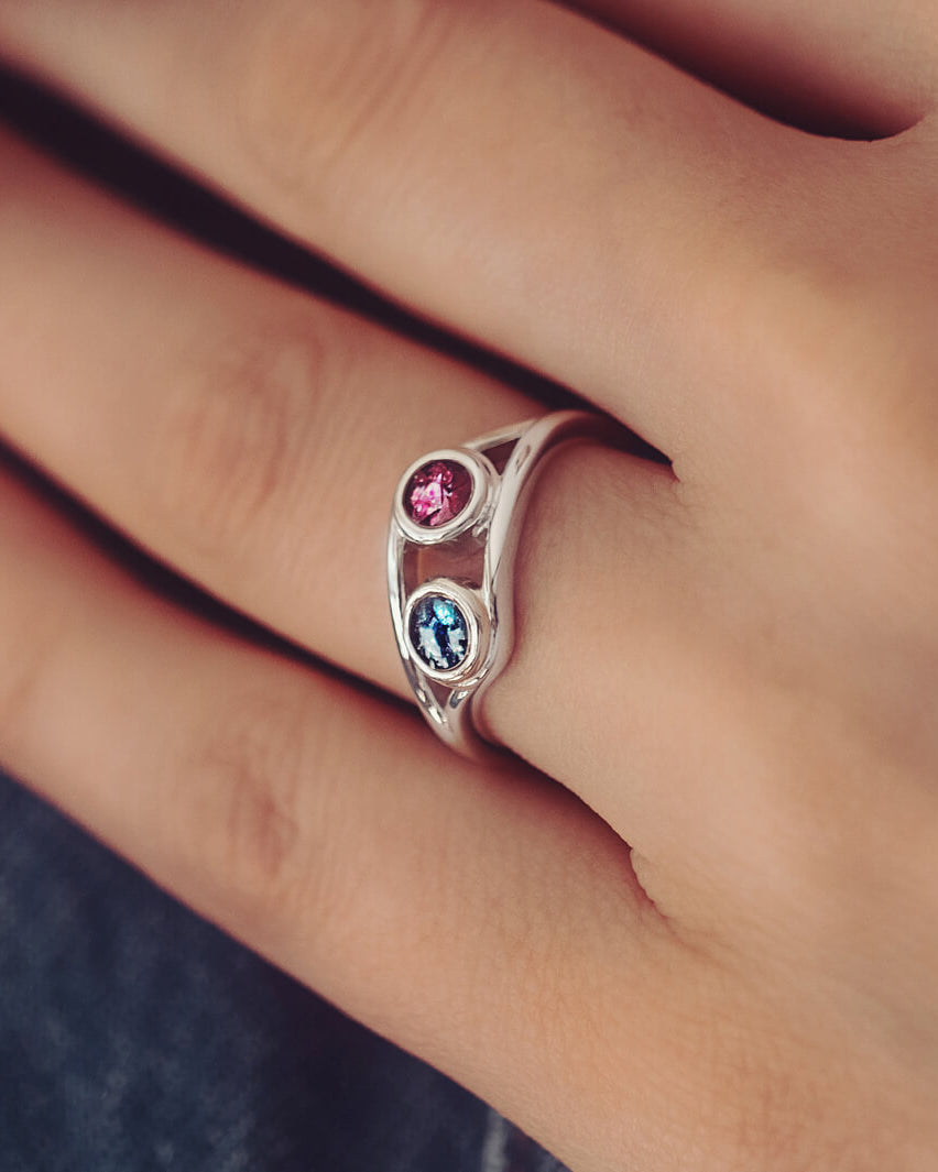 sterling silver ring with two circles created with coloured crystal and cremation ashes.