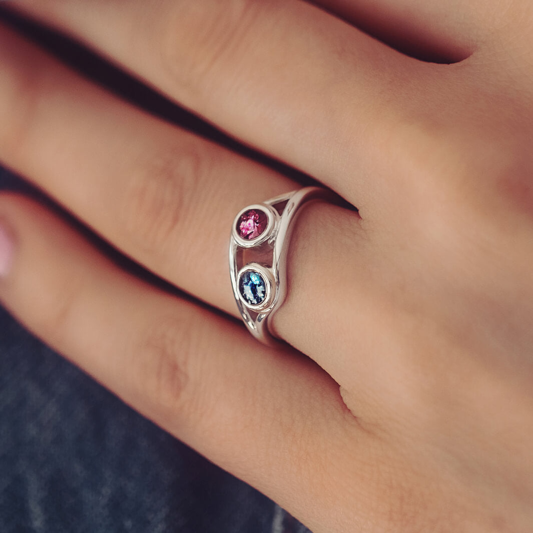 sterling silver ring with two circles created with coloured crystal and cremation ashes.