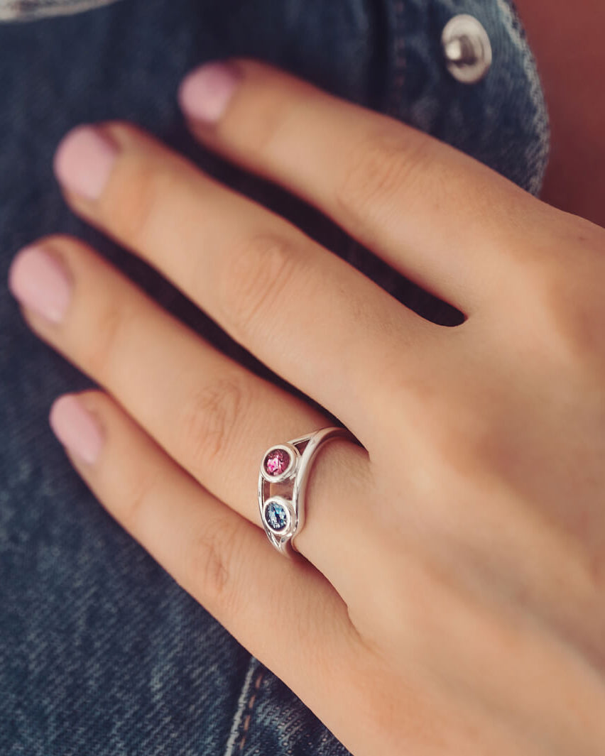 sterling silver ring with two circles created with coloured crystal and cremation ashes.