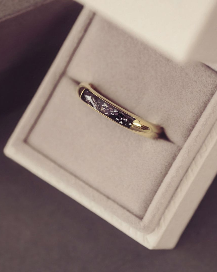 Gold ring with embedded stones in a jewelry box