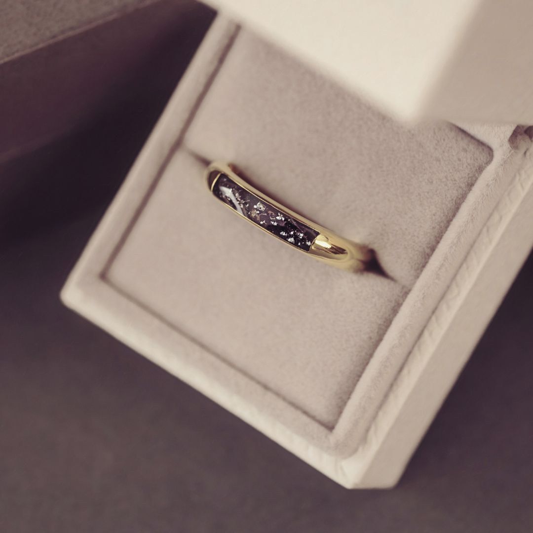 Gold ring with embedded stones in a jewelry box