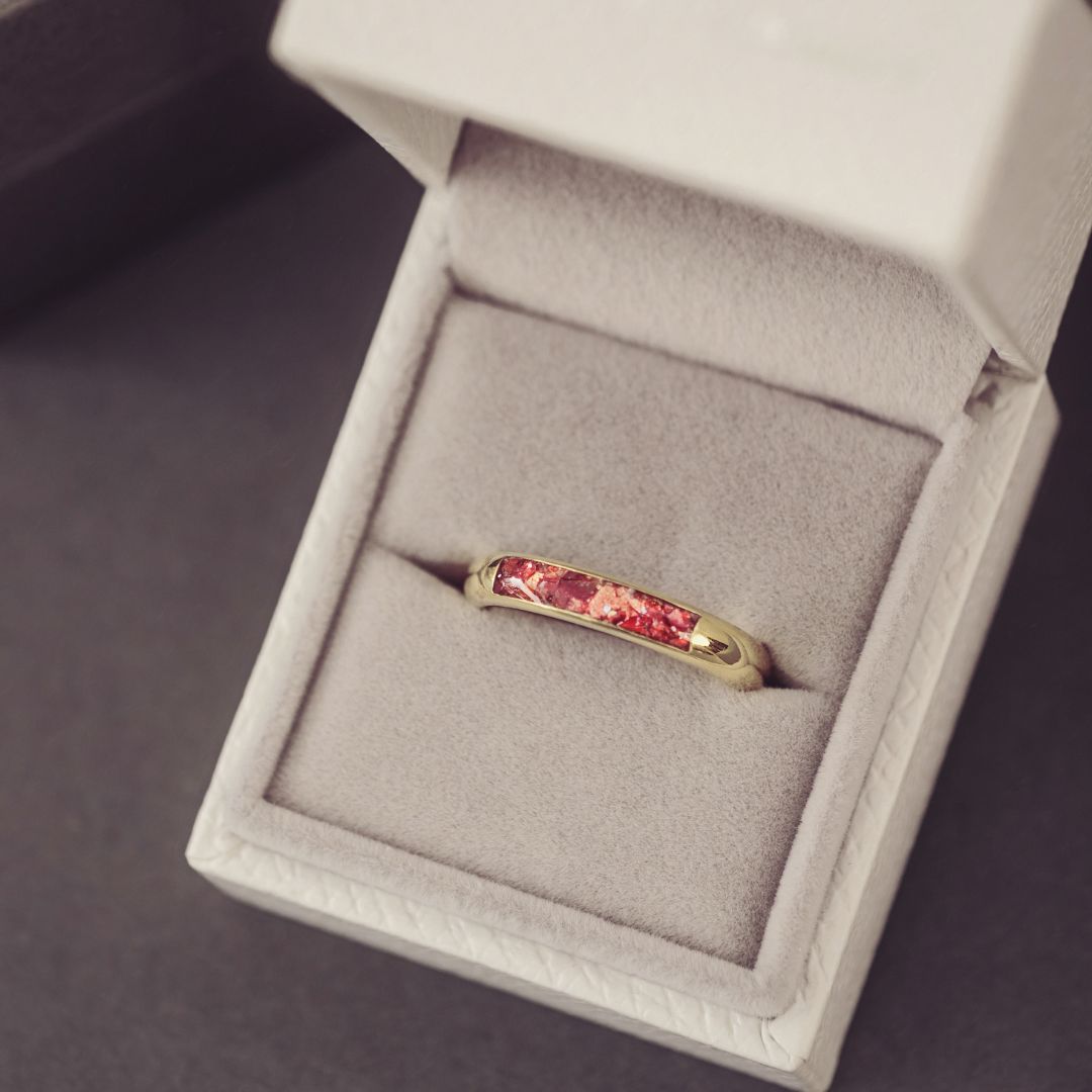 Gold ring with red gemstone in a jewelry box