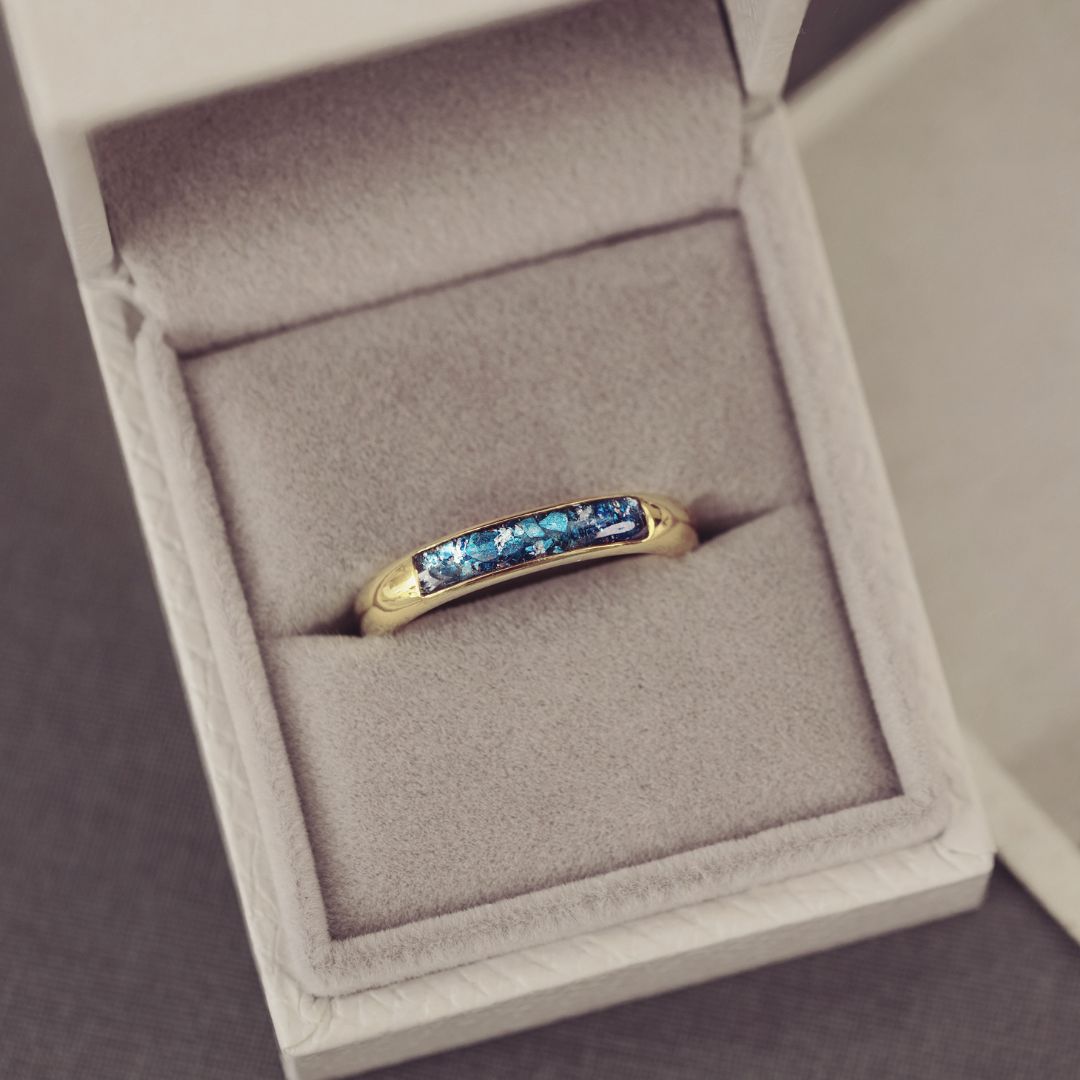Gold ring with blue gemstones in a jewelry box